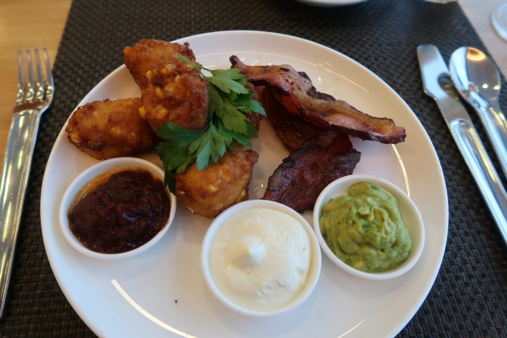sweet corn fritters with bacon, avocado, salsa and sour cream